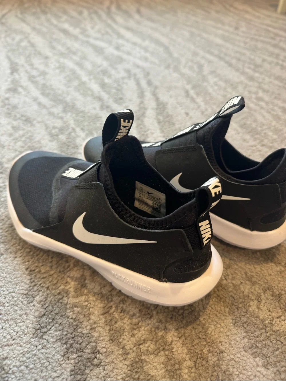 Brand new Nike Kids Black Slip-On Sneakers with White Sole and Branded Pull Tabs